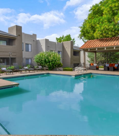 a swimming pool with a building in the background
