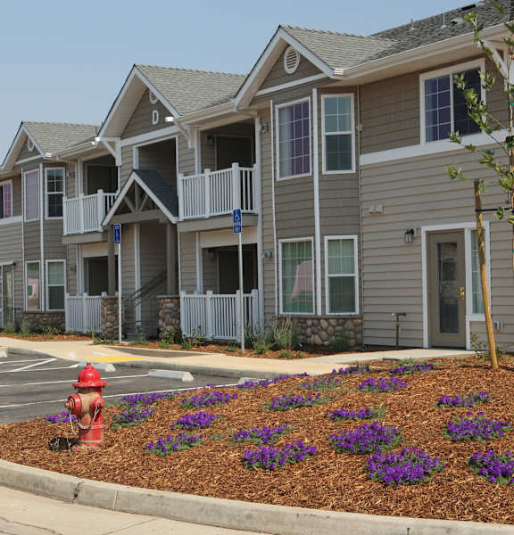 a fire hydrant in front of an apartment complex