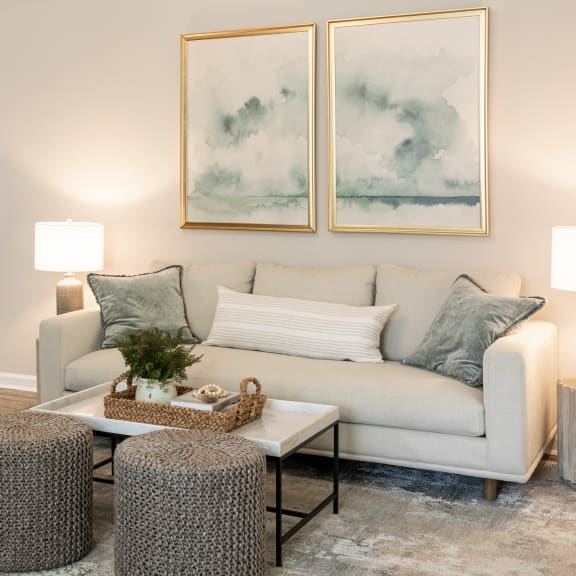 a living room with blue couches and chairs and a fireplace