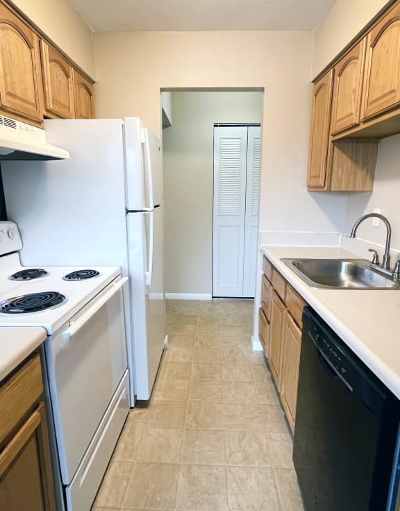 a kitchen with white appliances and wooden cabinets at Crown Pointe Apartments, Kentucky, 41014