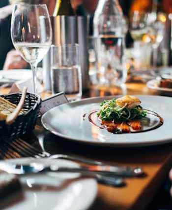 A person is holding a plate with food on it.