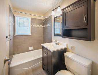 A bathroom with a white tub, sink, and toilet at Rivercrest Apartments, Piscataway , NJ, 08854