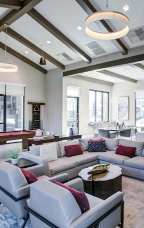clubroom with a large grey sofa and a coffee table.