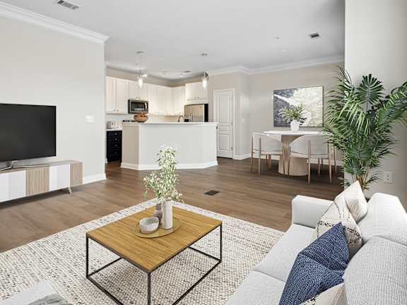 A modern living room with a large abstract painting on the wall and a wooden floor.
