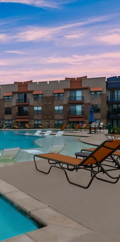Exterior pool view at Soho Parkway with lounge chairs