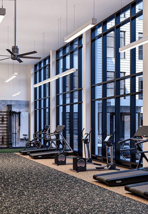a view of the fitness center with cardio machines and other exercise equipment at The Willard Apartments, Owings Mills, MD