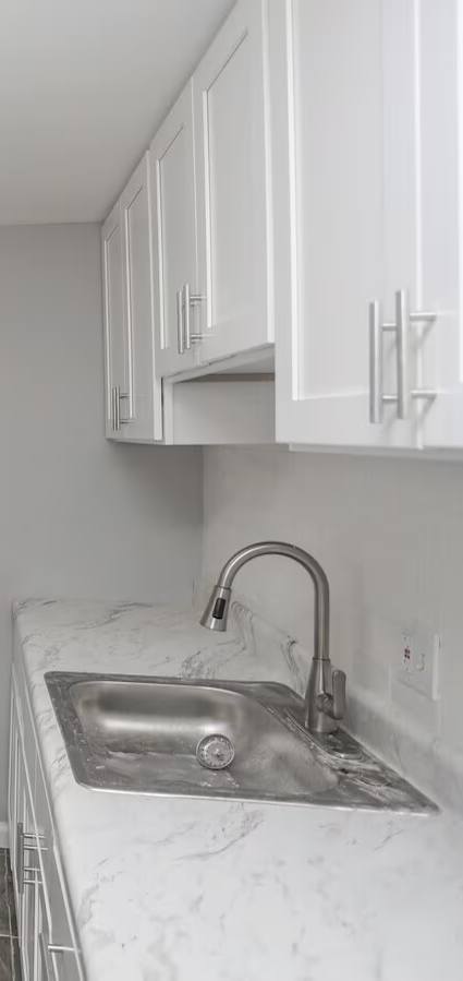 Clean White Updated Bathroom with sink, shower and toilet. 