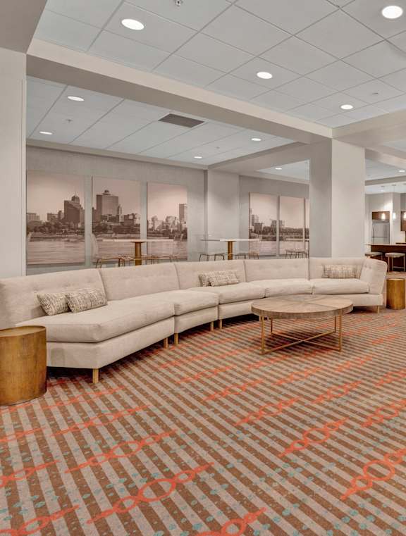 A reception area with a marble floor and a wooden reception desk.