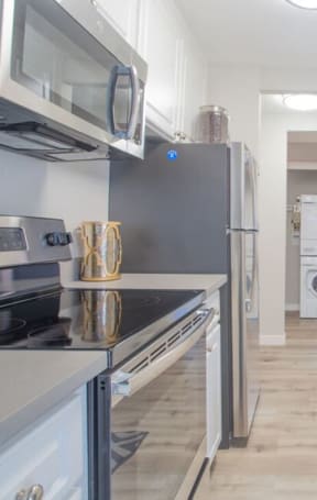 a kitchen with white cabinets and stainless steel appliances at Sunnyvale Crossings Apartments, LLC, Sunnyvale, CA 94087