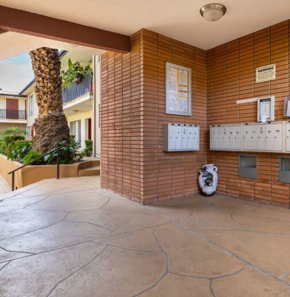 the lobby or reception area of a building with a urinal and a palm tree