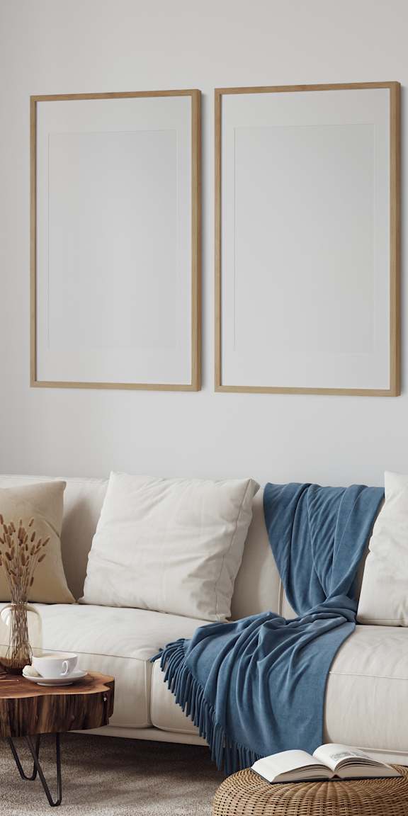 A living room with a white couch, a coffee table, and a wicker cabinet.