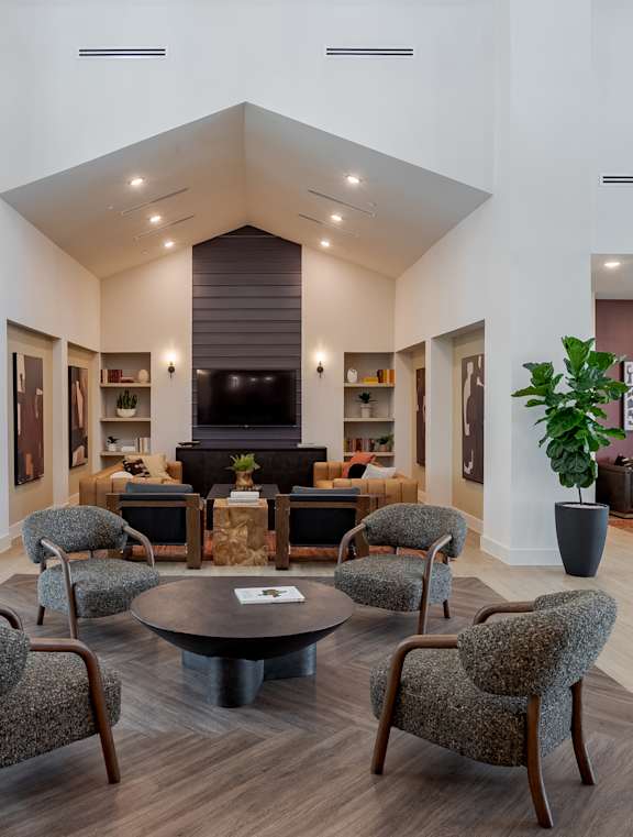 A living room with a large couch, a coffee table, and a television. at Northwoods, Texas, 77388