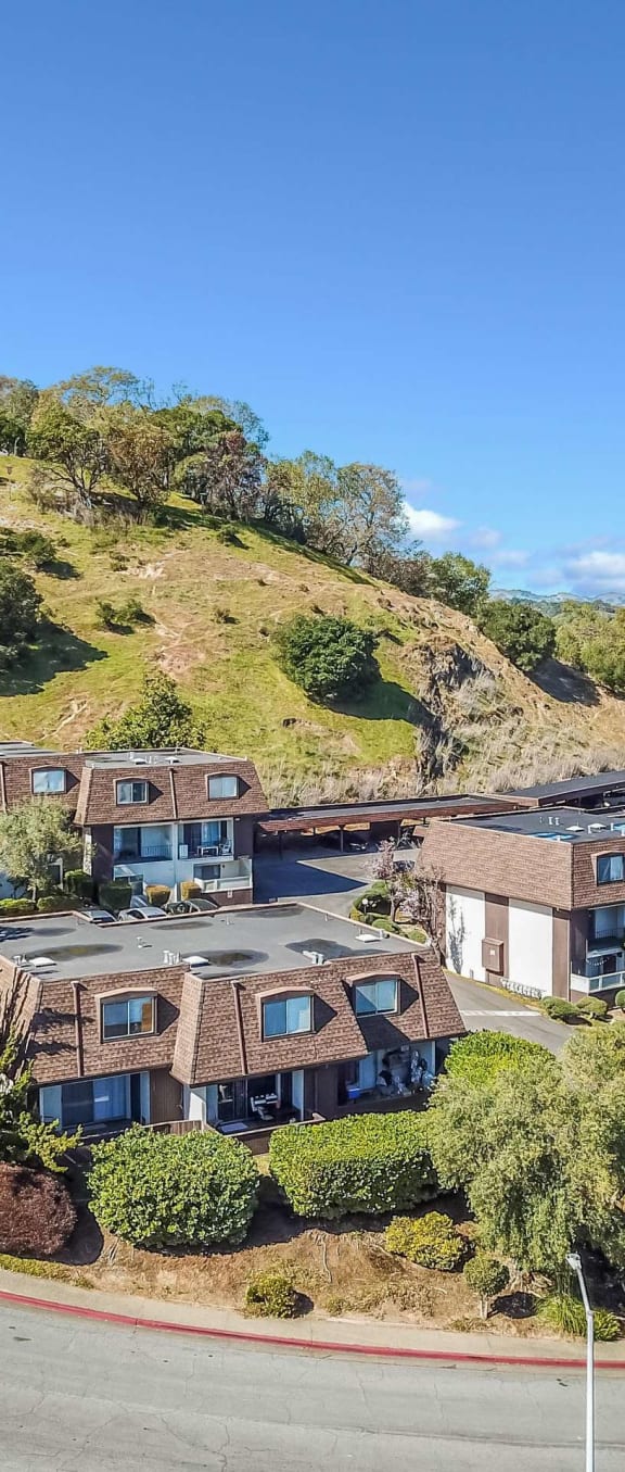 aerial view of apartment buildings and hillside