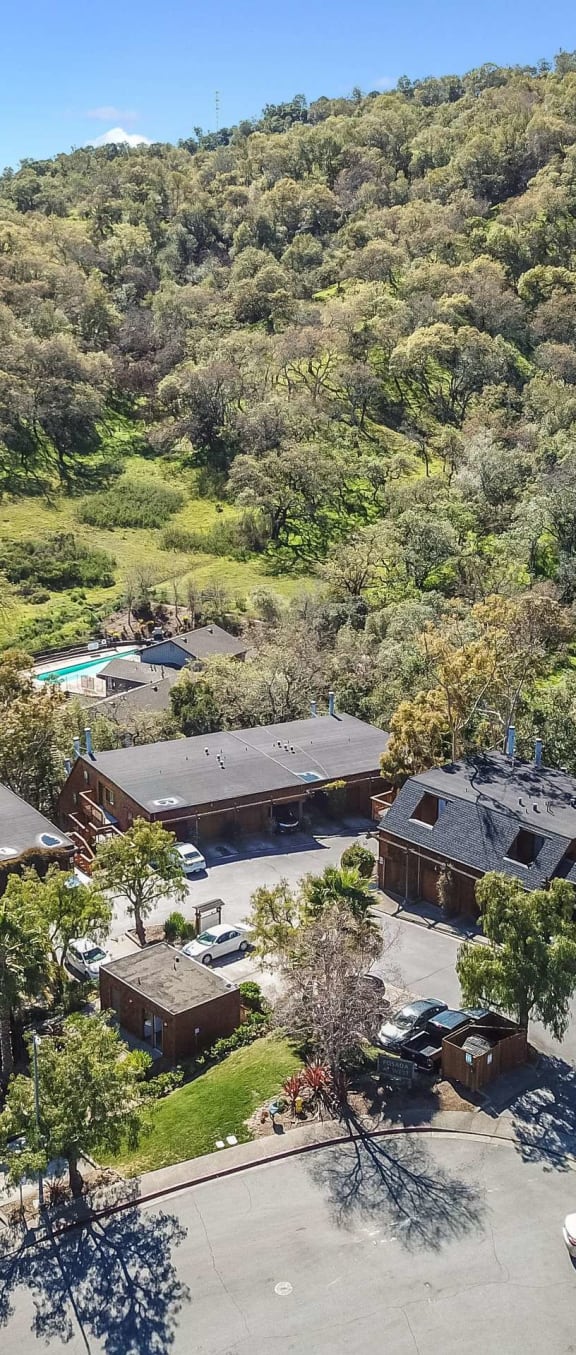 aerial view of apartment buildings and hillside