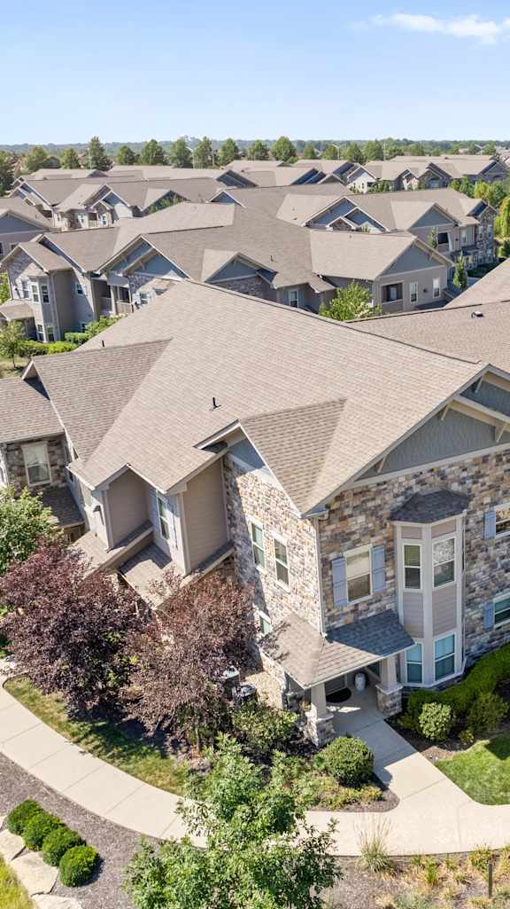 An aerial view of the apartment buildings & landscaping at Stonepost Crossing Apartments in Overland Park, KS.