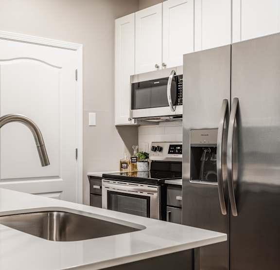 Luxury kitchen with stainless appliances and a sink at Alexandria of Carmel Apartments, Carmel, IN