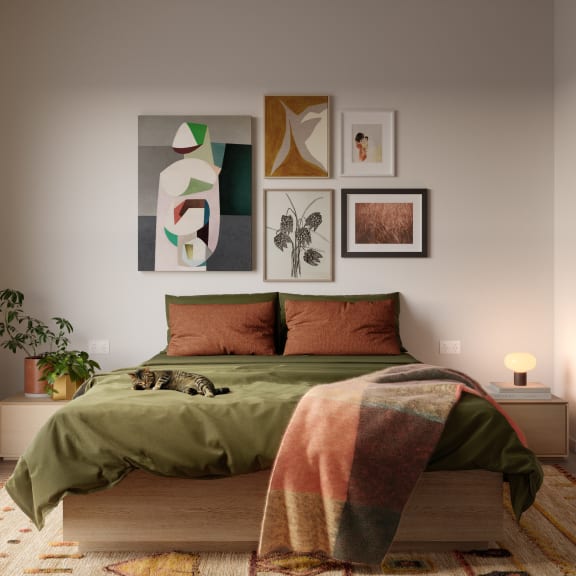 a bedroom with a bed and paintings on the wall