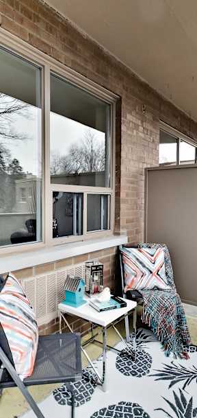 a living room with a couch and a table on a balcony