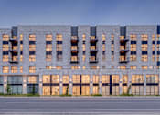 Thumbnail 36 of 36 - A modern building with a lot of windows and balconies.