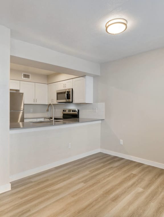 a large living room with a kitchen and a dining room