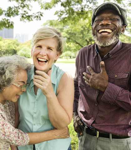 a group of people laughing together in a park at Mariposa at Bay Colony, Dickinson, TX