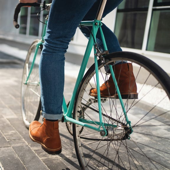 a person riding a bike down a street