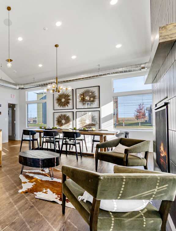 A modern kitchen with wooden floors and a stone backsplash.