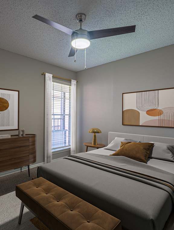 A bedroom with a bed, nightstand, and a ceiling fan.