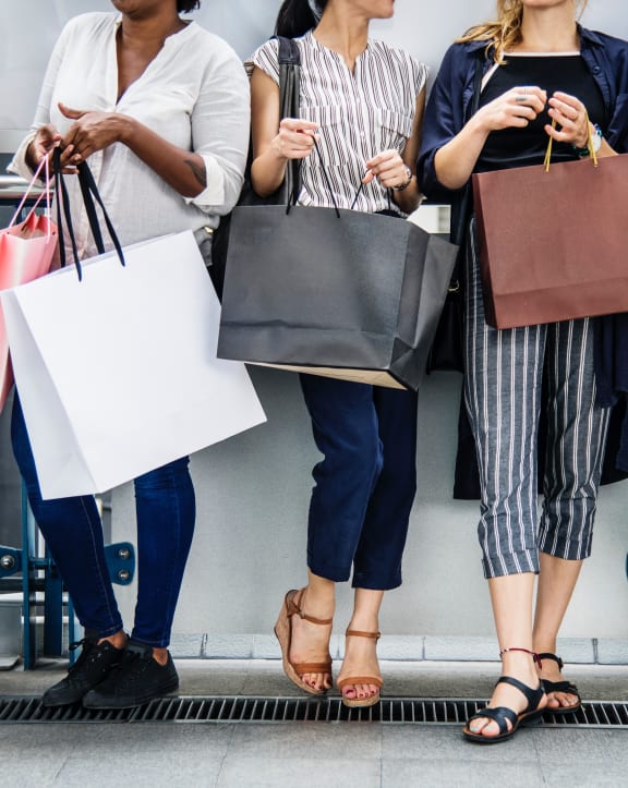 a group of people holding shopping bags