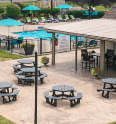 an aerial view of a playground and a pavilion with picnic tables