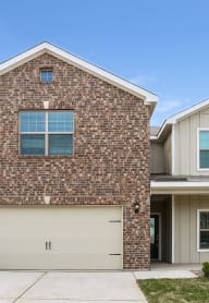 a brick house with a white garage door