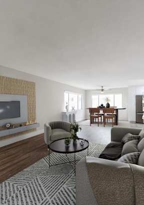 A modern living room with a grey sofa and a television.