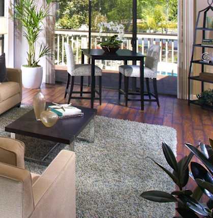 a living room with a couch and a table and a balcony