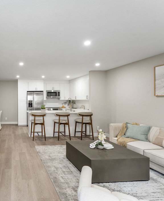 Ocean Edge at Laguna Beach modern kitchen with a bar stool and a couch.at Tamarack Sands Apartment Homes, Carlsbad, CA, 92008