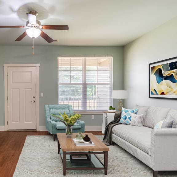 a living room with blue couches and chairs and a fireplace
