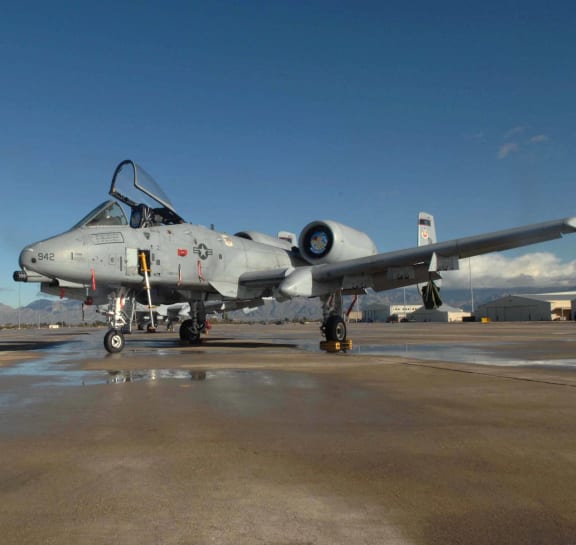 a fighter jet sitting on top of an airport runway