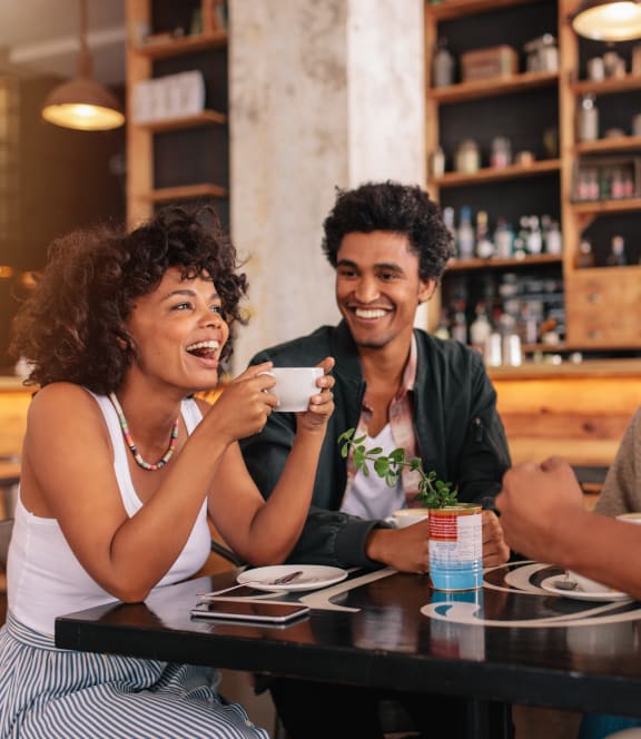 a group of people sitting around a table in a restaurant