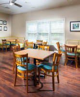a dining room with tables and chairs and a couch