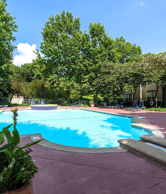 A sparkling pool with lounge chairs and umbrellas for a relaxing afternoon.