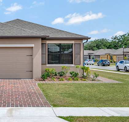 A house with a garage door that says "BUILT" on it.