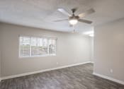 Thumbnail 3 of 34 - A room with a ceiling fan and a window with blinds.