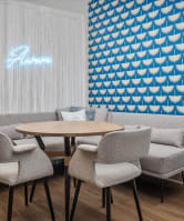 a small seating area with tables chairs and a couch