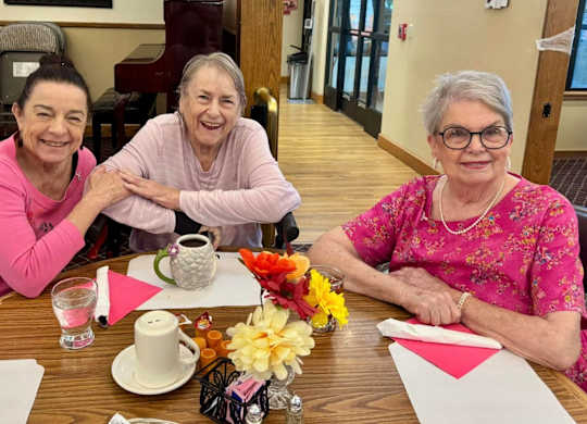 Three women sitting at a table at River Commons Senior Living, California, 96002