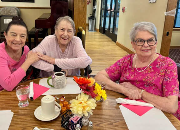 Three women sitting at a table at River Commons Senior Living, California, 96002