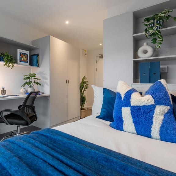 a bedroom with a bed and a desk