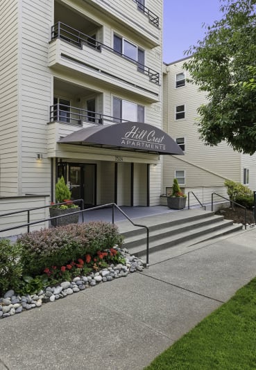 a view of the front of the building with the steps leading up to the entrance at Hill Crest Apartment Homes, WA 98126