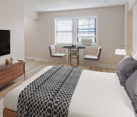 a bedroom with a bed and a television