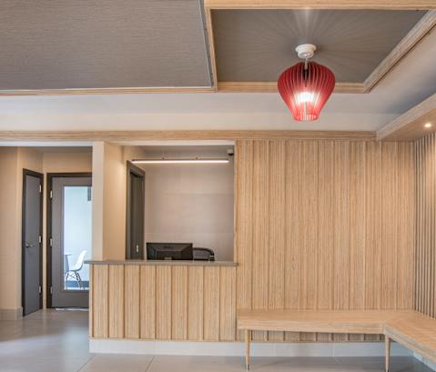 a lobby with a bench and a wooden wall and a red light