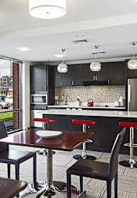 a kitchen and dining room with a view of a parking lot