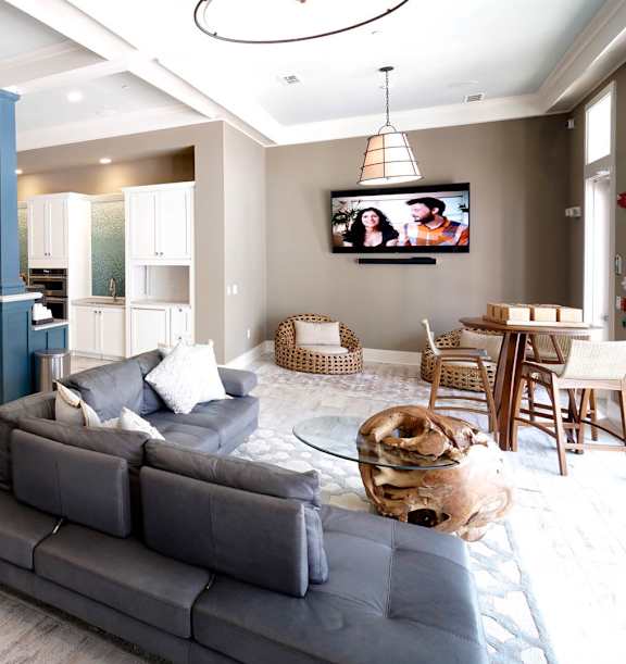 A living room with a couch, chairs, and a coffee table.